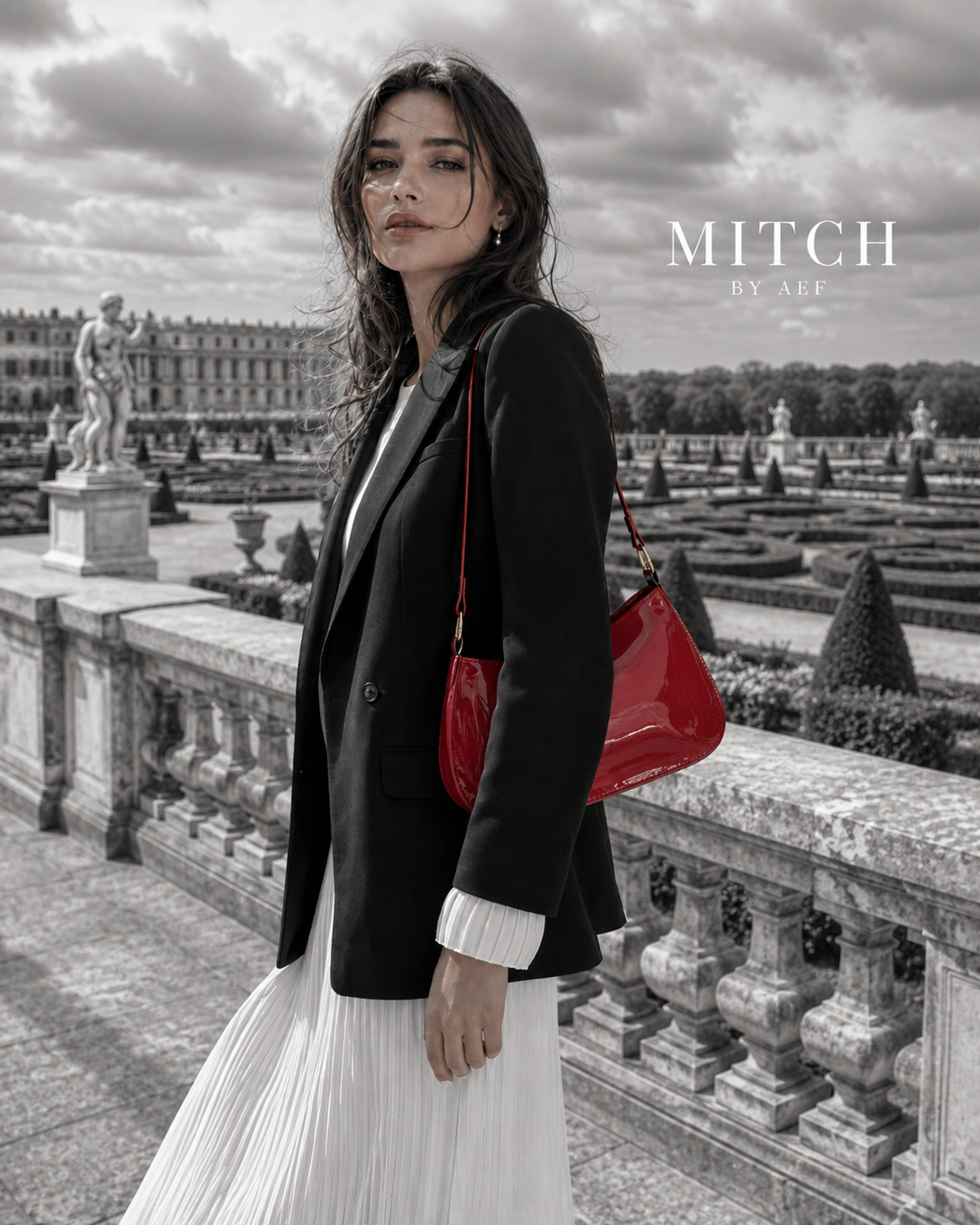 Sac rouge verni porté à l’épaule avec blazer noir dans les jardins de Versailles #Cerise Fatale